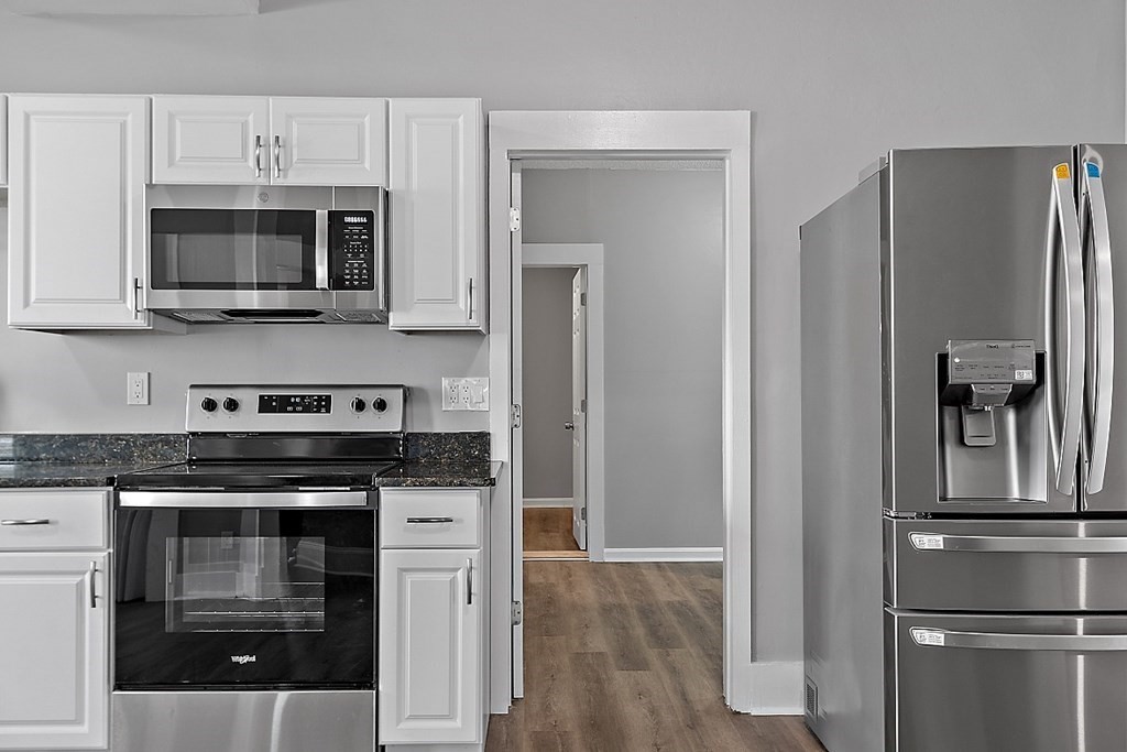 46 West Meadow Road Lowell, MA 01854 - Photo 19 of 42 a kitchen with stainless steel appliances a stove a microwave and a hard wood floor