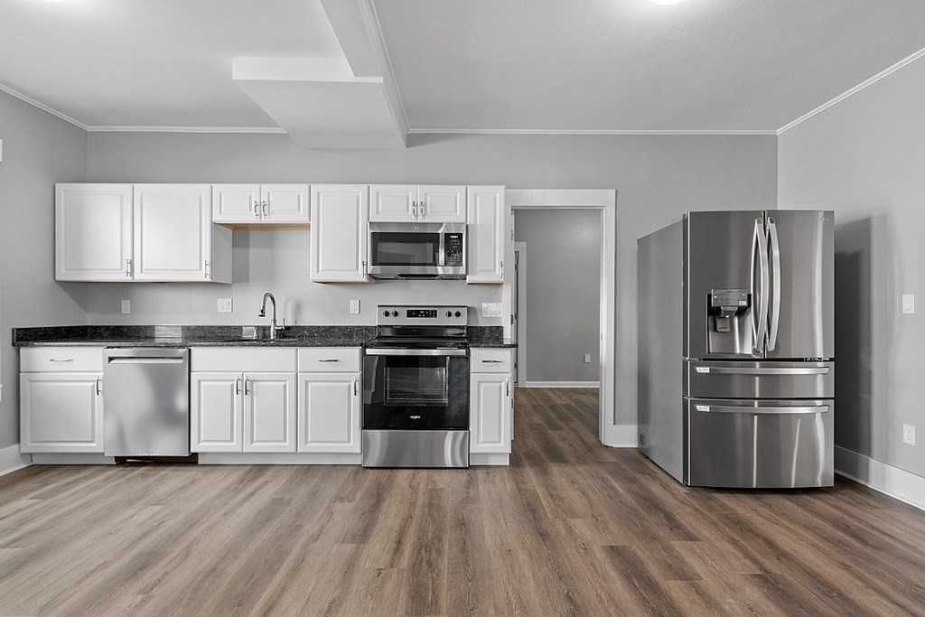 46 West Meadow Road Lowell, MA 01854 - Photo 2 of 42 a kitchen with granite countertop a refrigerator and a stove top oven
