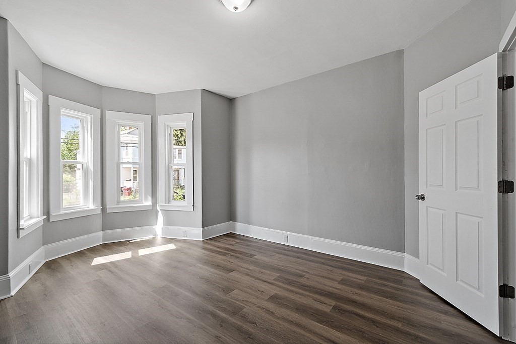46 West Meadow Road Lowell, MA 01854 - Photo 22 of 42 a view of an empty room with wooden floor and a window