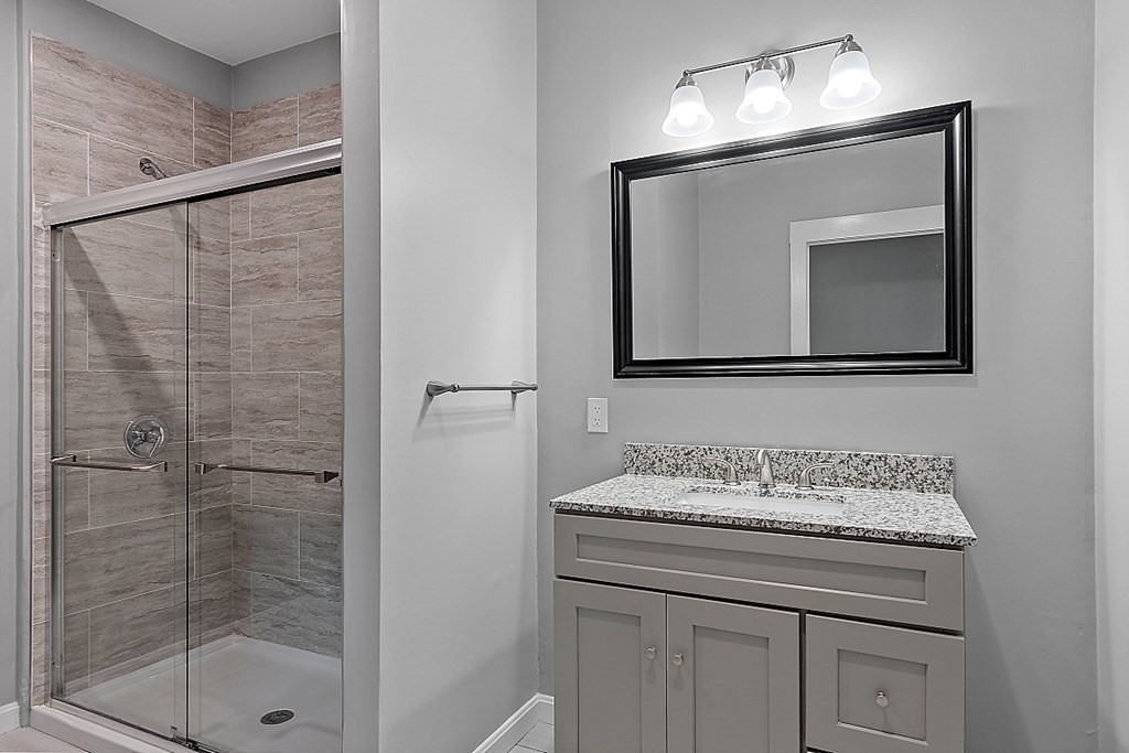 46 West Meadow Road Lowell, MA 01854 - Photo 23 of 42 a bathroom with a sink a mirror and a shower