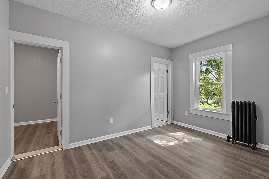 46 West Meadow Road Lowell, MA 01854 - Photo 26 of 42 an empty room with wooden floor and windows