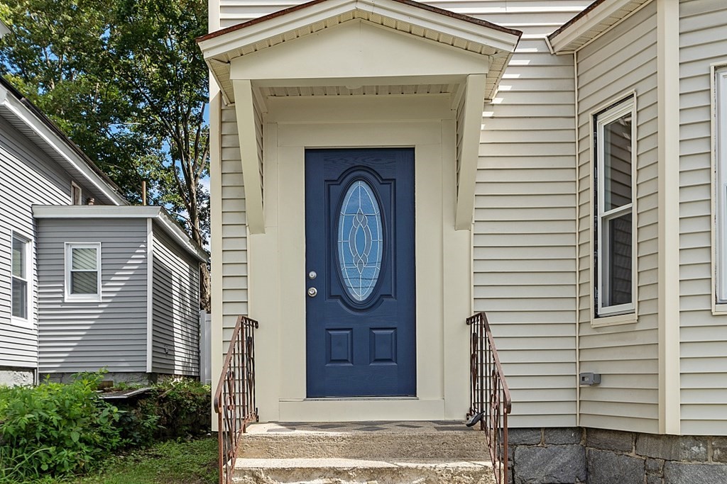 46 West Meadow Road Lowell, MA 01854 - Photo 3 of 42 a front view of a house with a garden