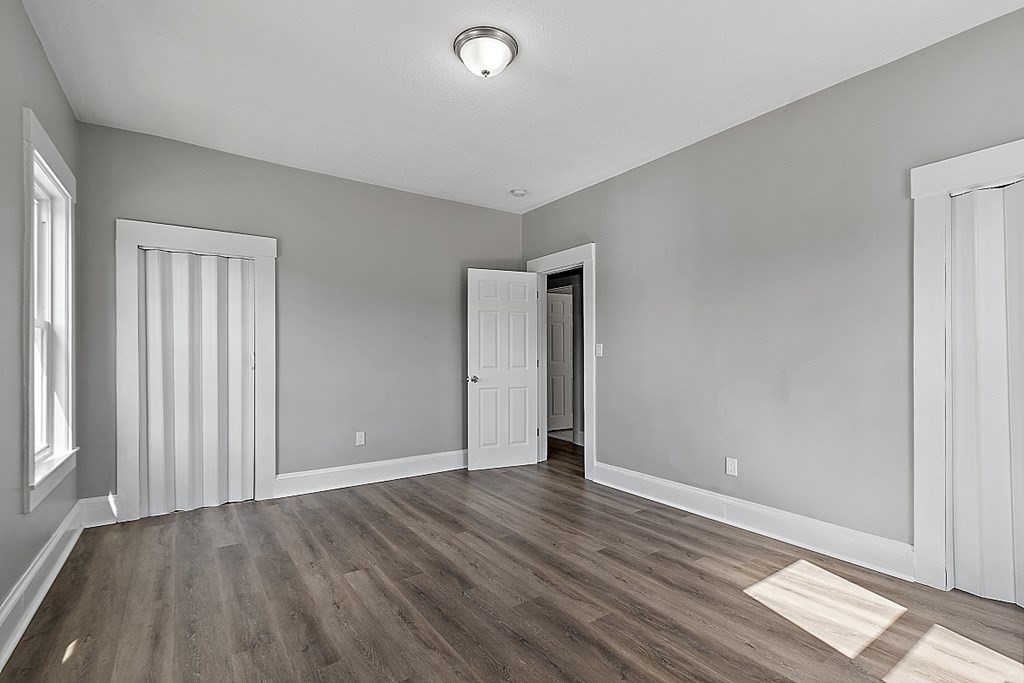 46 West Meadow Road Lowell, MA 01854 - Photo 34 of 42 an empty room with wooden floor and windows