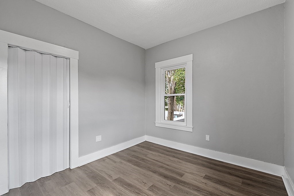 46 West Meadow Road Lowell, MA 01854 - Photo 36 of 42 an empty room with wooden floor and windows