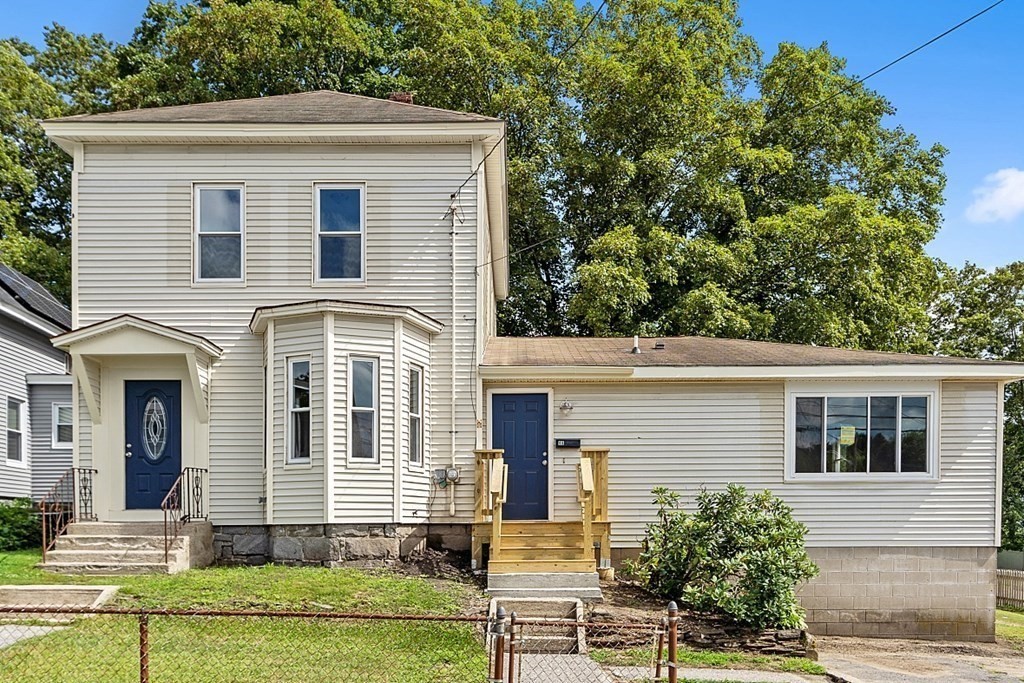46 West Meadow Road Lowell, MA 01854 - Photo 40 of 42 front view of a house with a yard