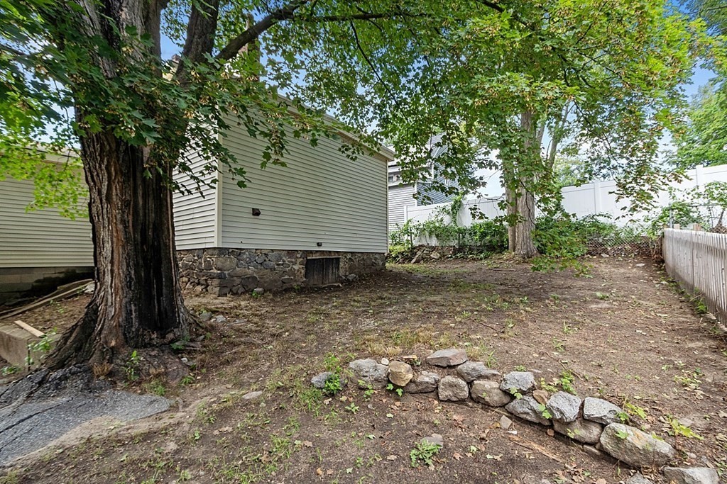 46 West Meadow Road Lowell, MA 01854 - Photo 42 of 42 a backyard of a house with lots of green space