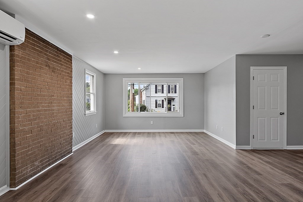 46 West Meadow Road Lowell, MA 01854 - Photo 9 of 42 a view of an empty room with wooden floor and a window