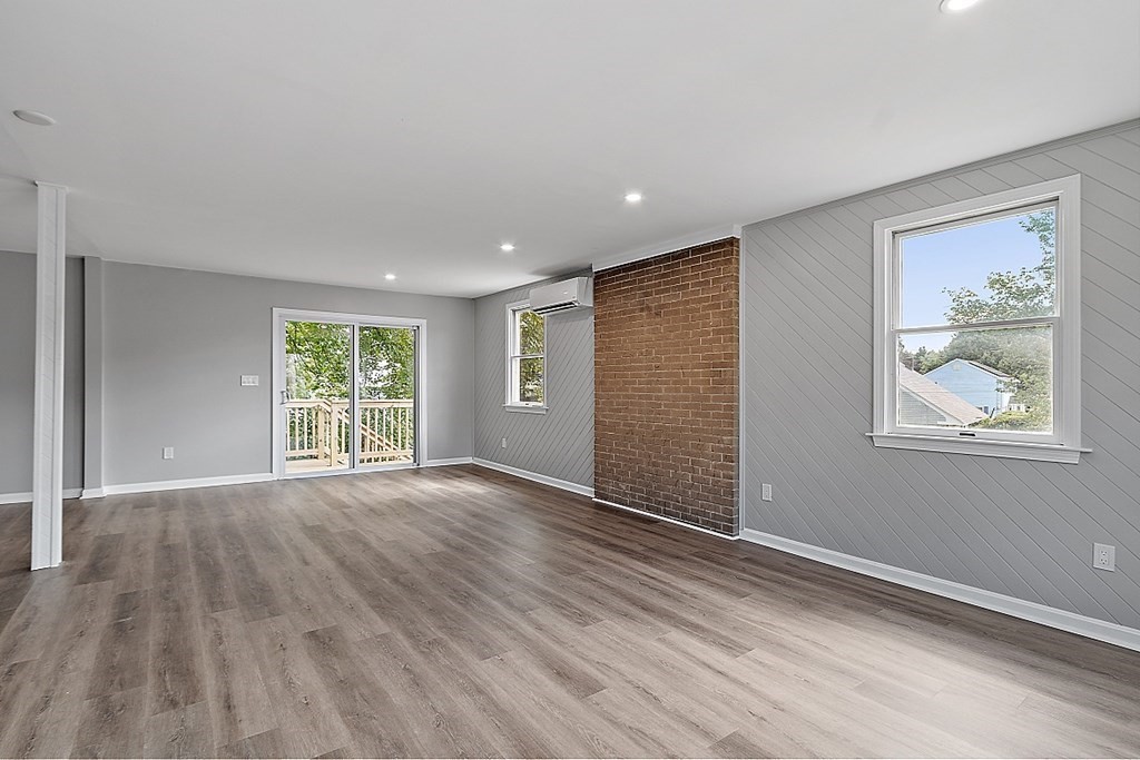 46 West Meadow Road Lowell, MA 01854 - Photo 10 of 42 a view of an empty room with wooden floor and a window
