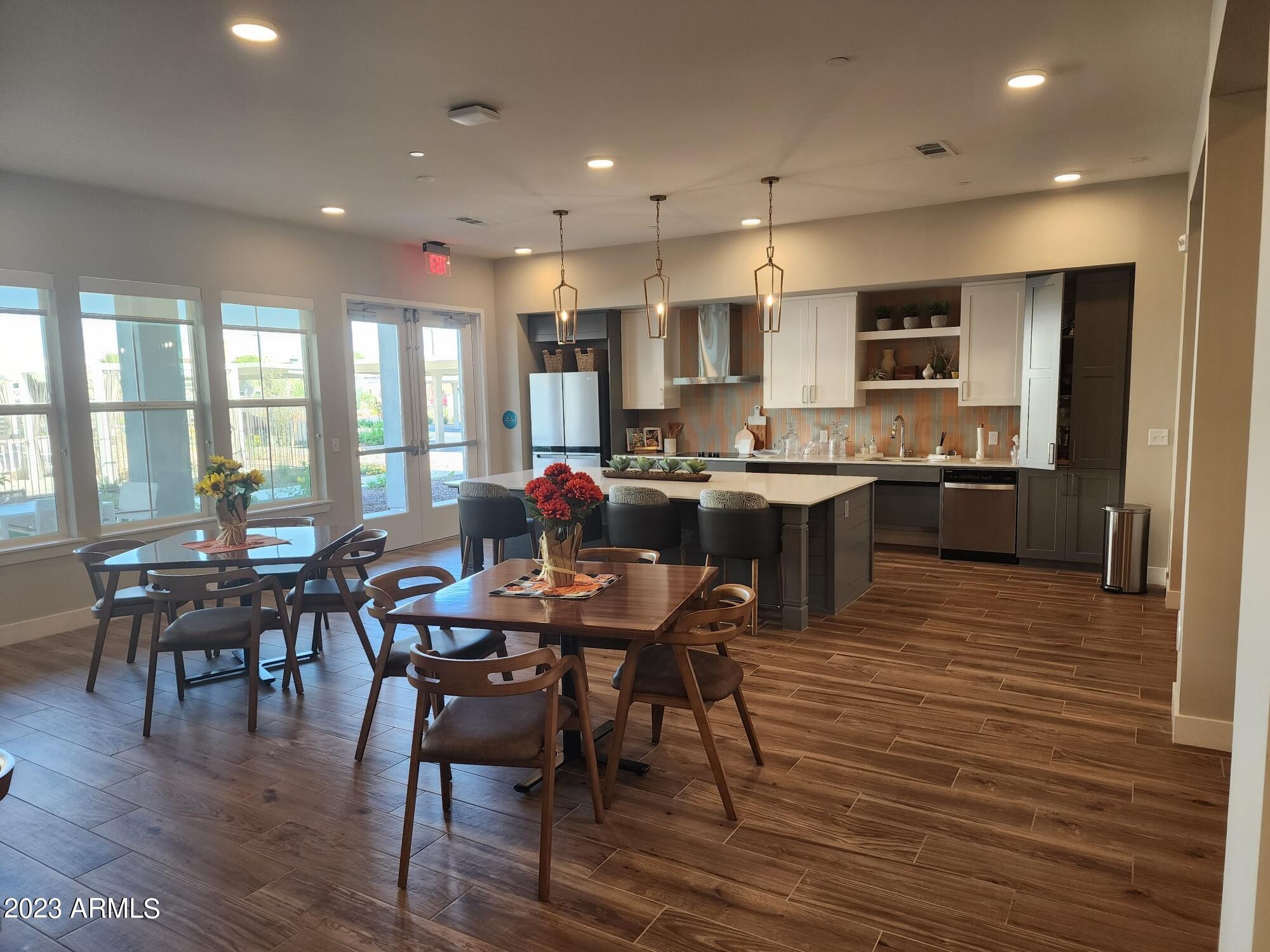 2050 West Pecos Road, Unit A3 Chandler, AZ 85224 - Photo 13 of 21 a view of a dining room with furniture window and wooden floor