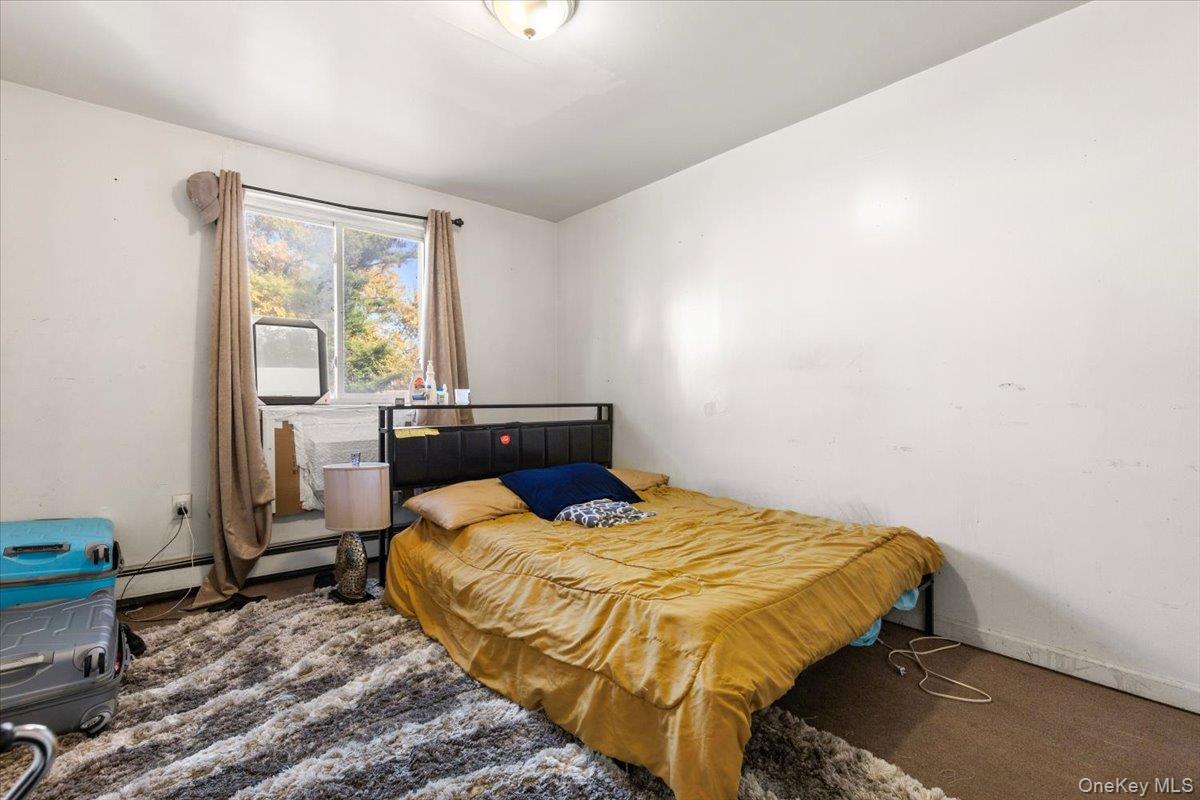 1827 Patterson Avenue Bronx, NY 10473 - Photo 11 of 31 a bedroom with a bed and wooden floor