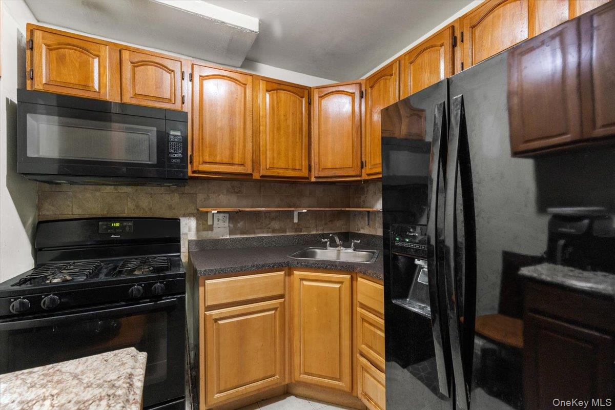 1827 Patterson Avenue Bronx, NY 10473 - Photo 23 of 31 a kitchen with a refrigerator stove and microwave
