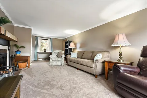 a living room with furniture and a lamp