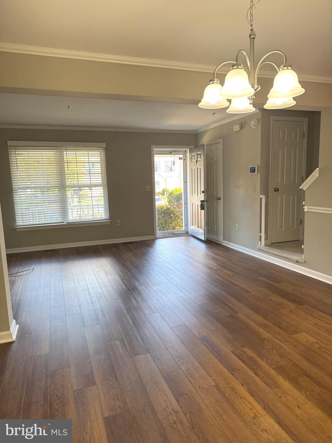 209 Hunters Run Terrace Bel Air, MD 21015 - Photo 4 of 17 a view of an empty room with wooden floor and a window