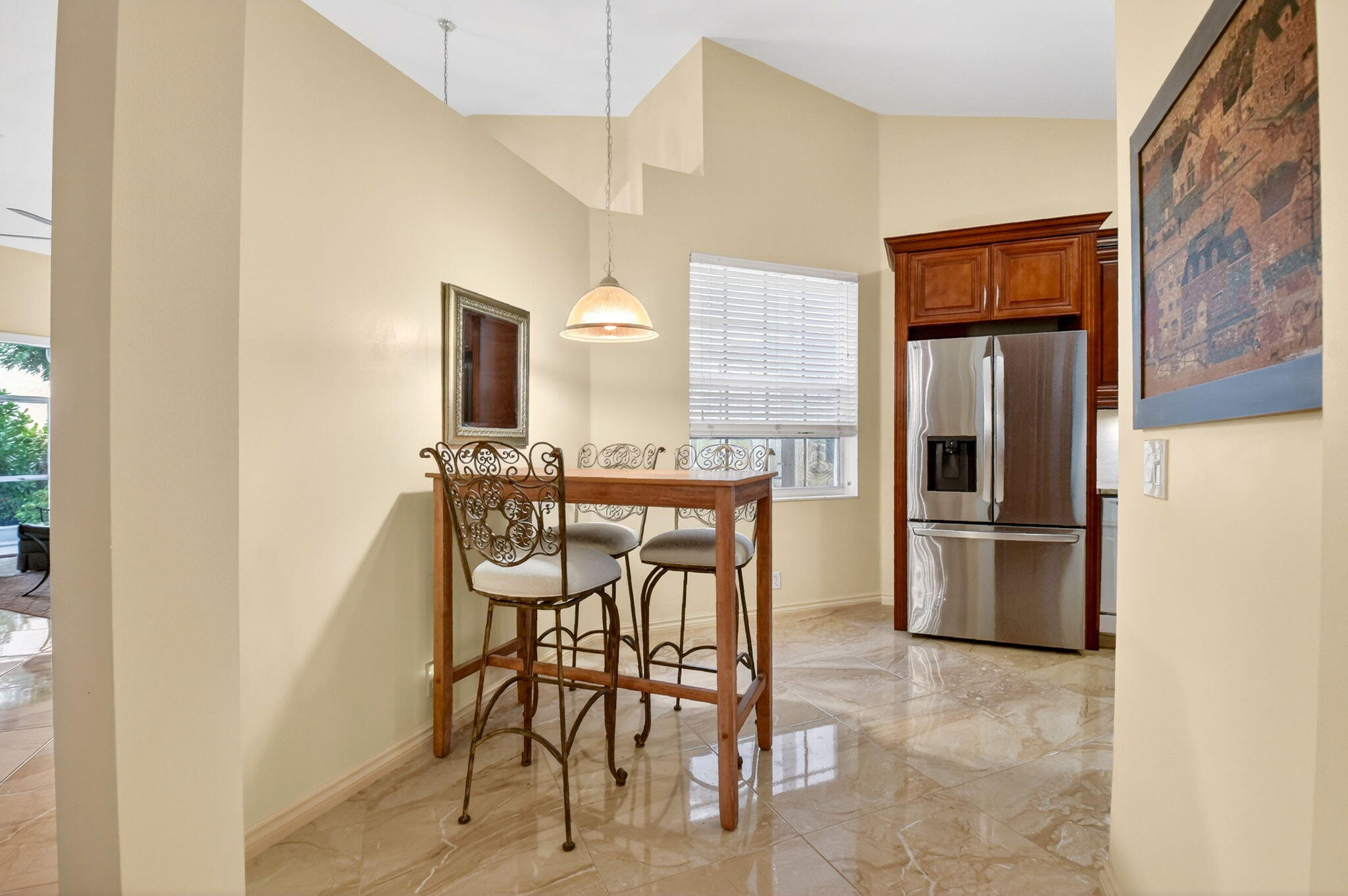 6164 Petunia Road Delray Beach, FL 33484 - Photo 16 of 62 a kitchen with stainless steel appliances kitchen island granite countertop dining table chairs and granite counter tops