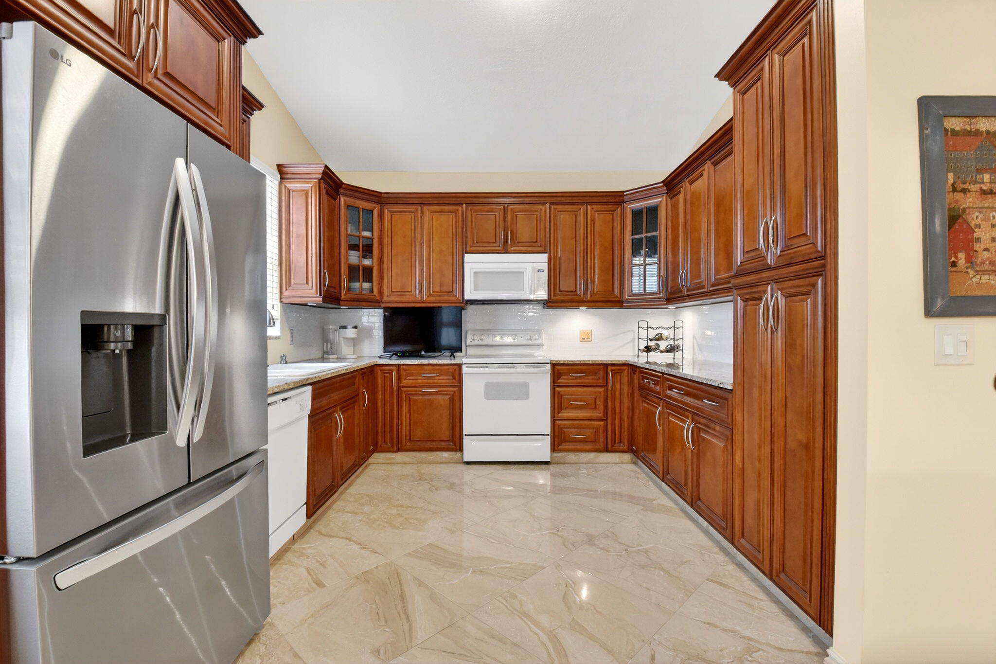6164 Petunia Road Delray Beach, FL 33484 - Photo 18 of 62 a kitchen with stainless steel appliances granite countertop a refrigerator and a stove top oven