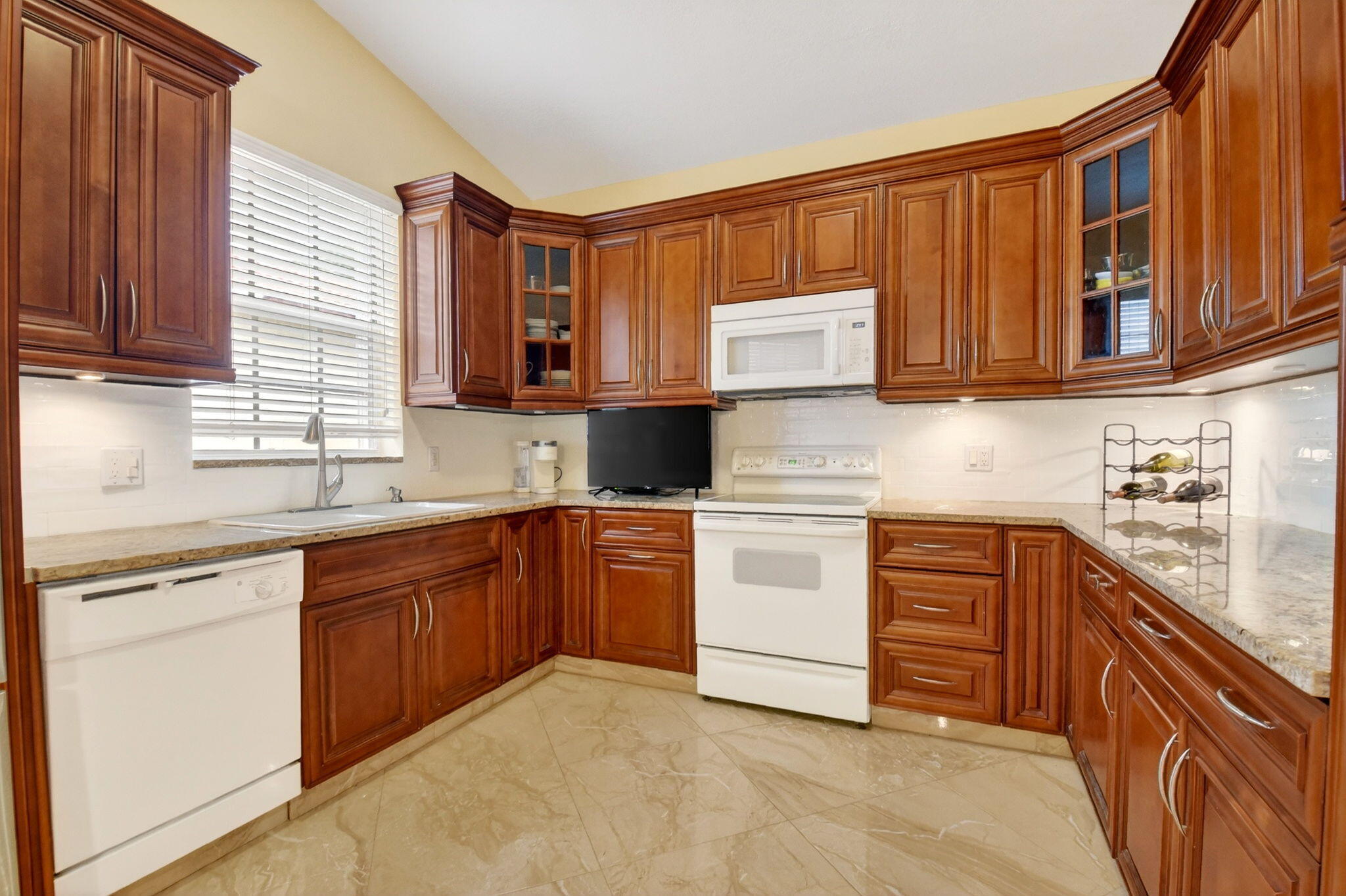 6164 Petunia Road Delray Beach, FL 33484 - Photo 19 of 62 a kitchen with stainless steel appliances granite countertop a sink stove and cabinets