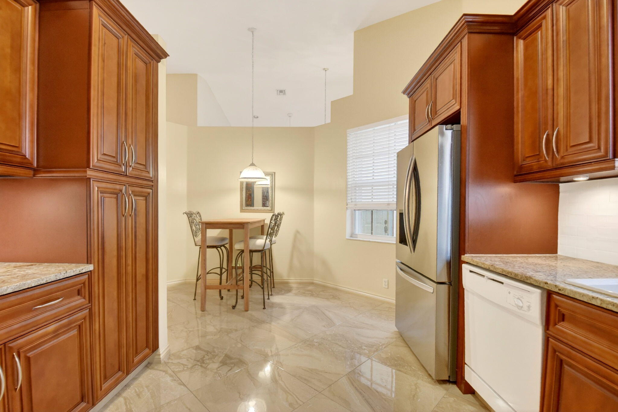6164 Petunia Road Delray Beach, FL 33484 - Photo 20 of 62 a kitchen with stainless steel appliances granite countertop a refrigerator and a stove