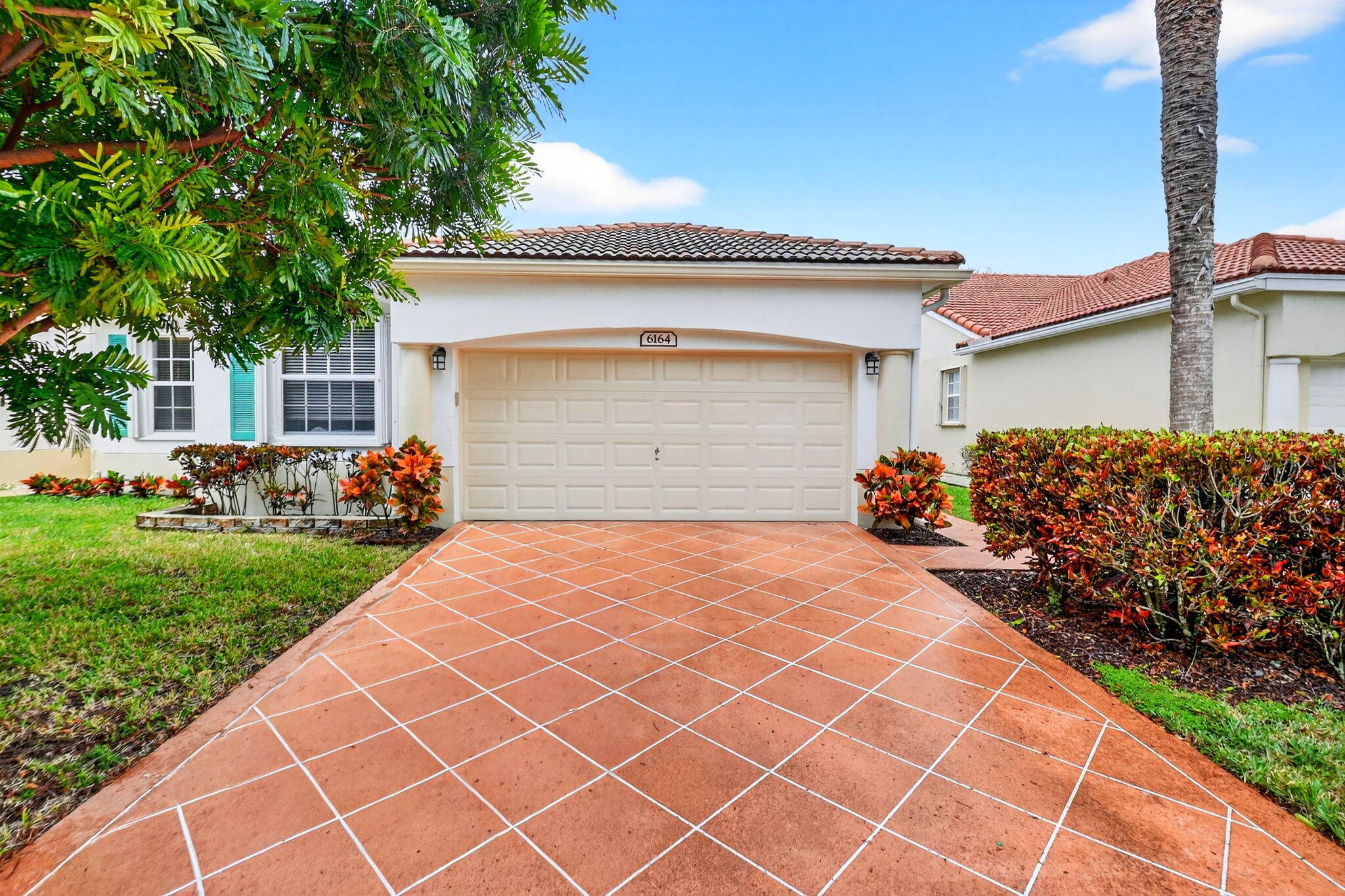 6164 Petunia Road Delray Beach, FL 33484 - Photo 2 of 62 front view of a house with a yard
