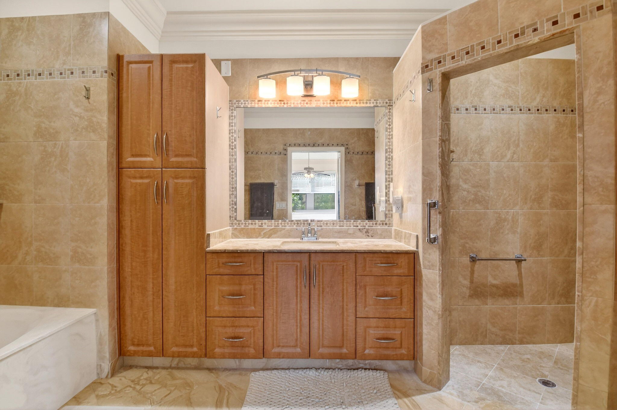 6164 Petunia Road Delray Beach, FL 33484 - Photo 26 of 62 a bathroom with a granite countertop sink a mirror and a shower