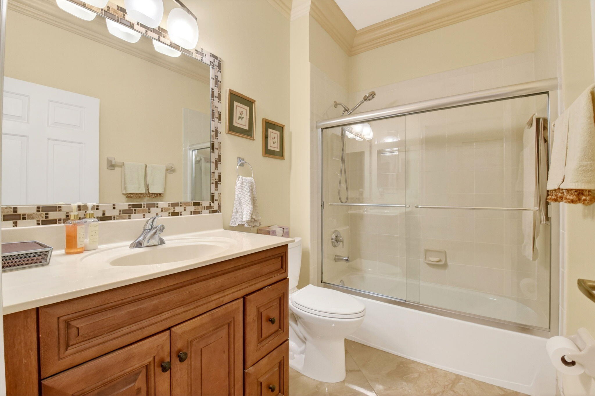 6164 Petunia Road Delray Beach, FL 33484 - Photo 38 of 62 a bathroom with a sink a toilet and shower