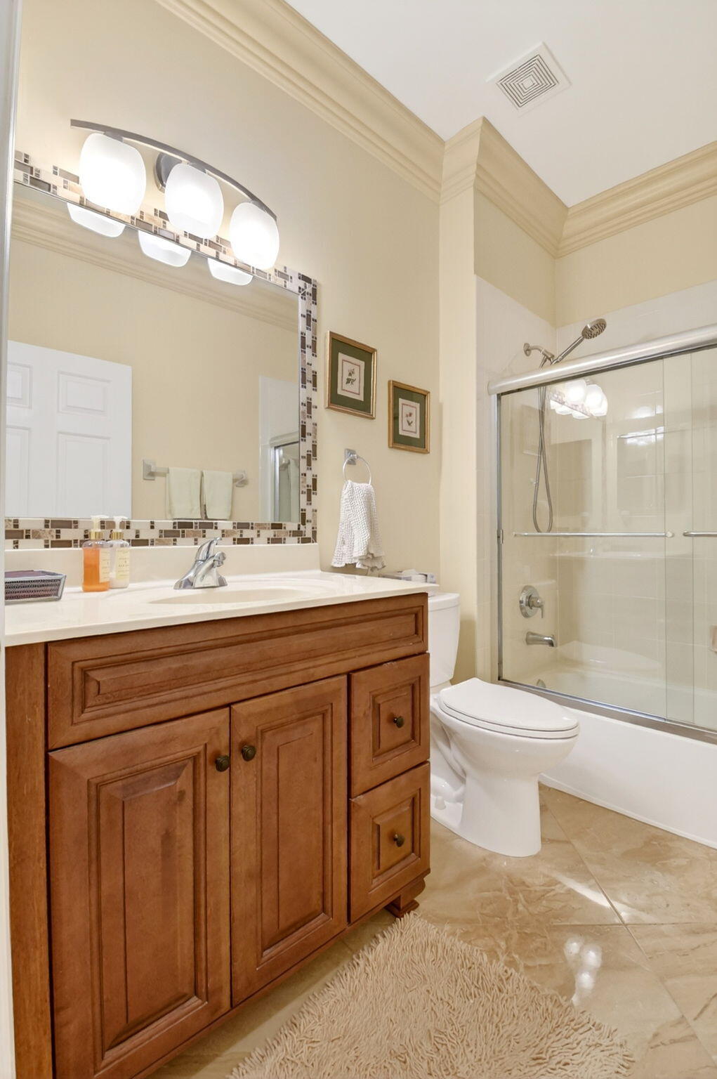 6164 Petunia Road Delray Beach, FL 33484 - Photo 39 of 62 a bathroom with a sink a toilet and a large mirror