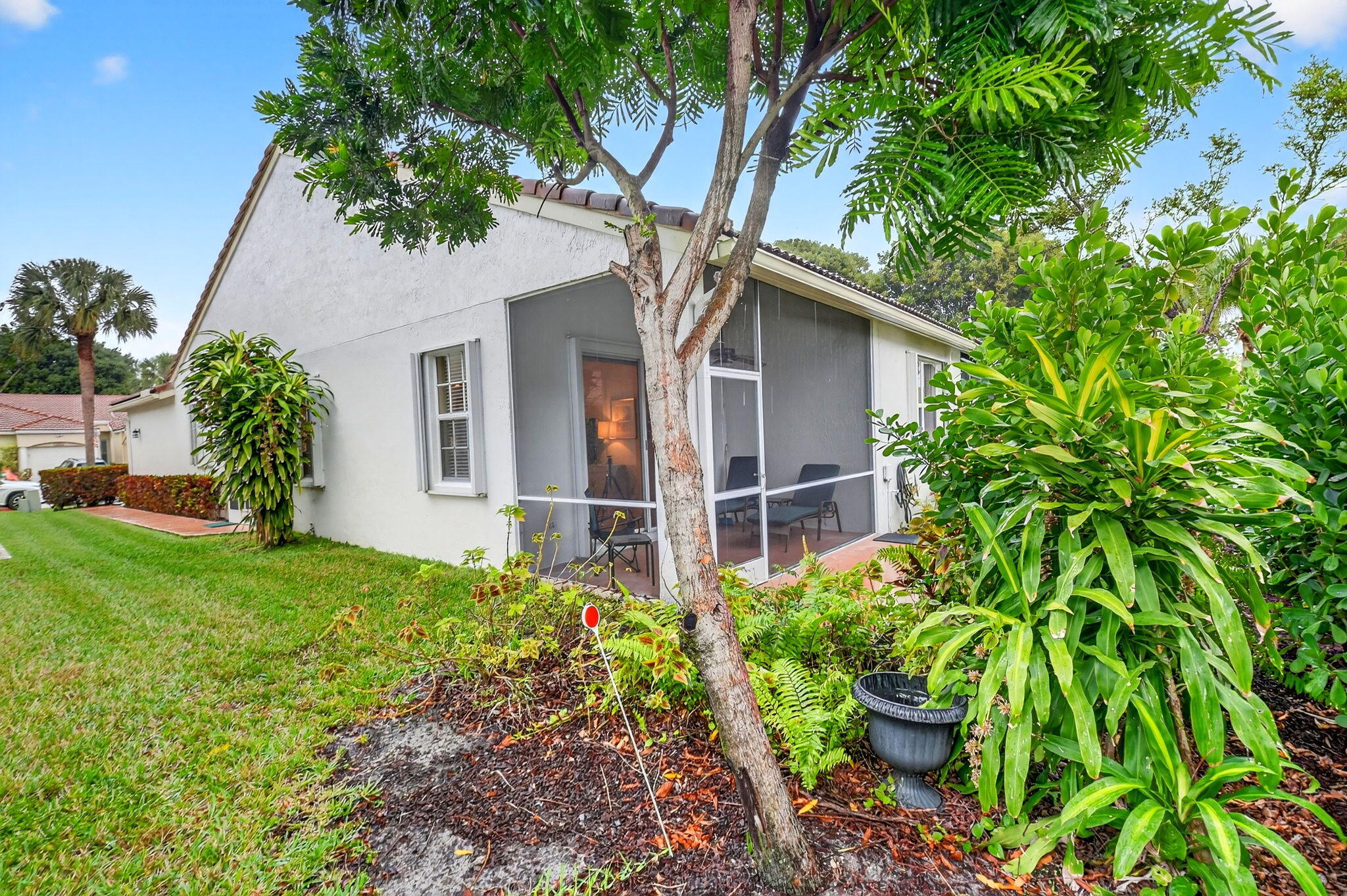 6164 Petunia Road Delray Beach, FL 33484 - Photo 44 of 62 a house with a tree in front of it