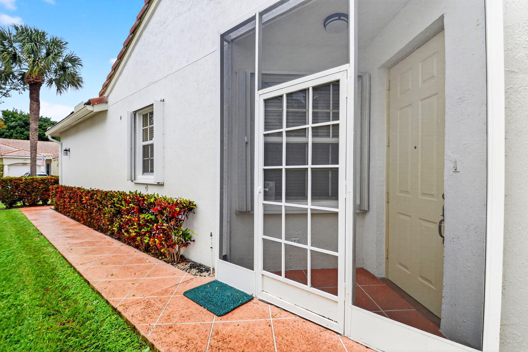 6164 Petunia Road Delray Beach, FL 33484 - Photo 5 of 62 a front view of a house with a yard and garage