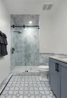 a bathroom with a toilet a sink and shower