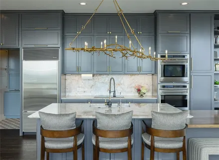 a kitchen with a table chairs refrigerator and cabinets