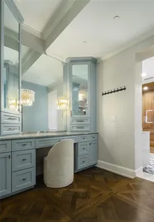 a bathroom with a granite countertop sink a mirror and a bathtub