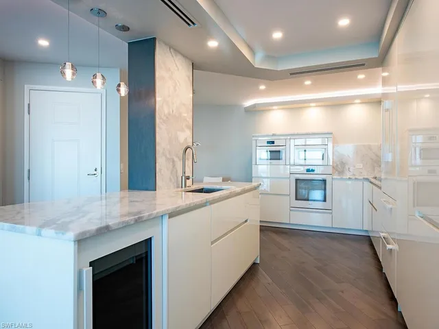 a large bathroom with a large mirror vanity and sink