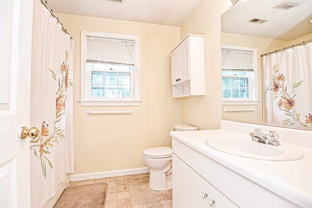 27 Crane Road, Unit 27 Walpole, MA 02081 - Photo 24 of 41 a bathroom with a granite countertop sink a toilet and a window