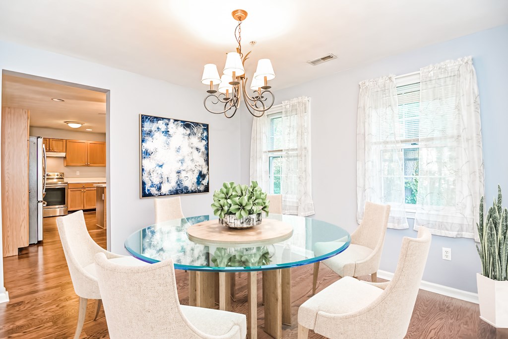 27 Crane Road, Unit 27 Walpole, MA 02081 - Photo 4 of 41 a view of a dining room with furniture a chandelier and wooden floor