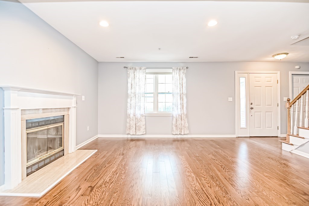27 Crane Road, Unit 27 Walpole, MA 02081 - Photo 8 of 41 a view of an empty room with wooden floor and a window