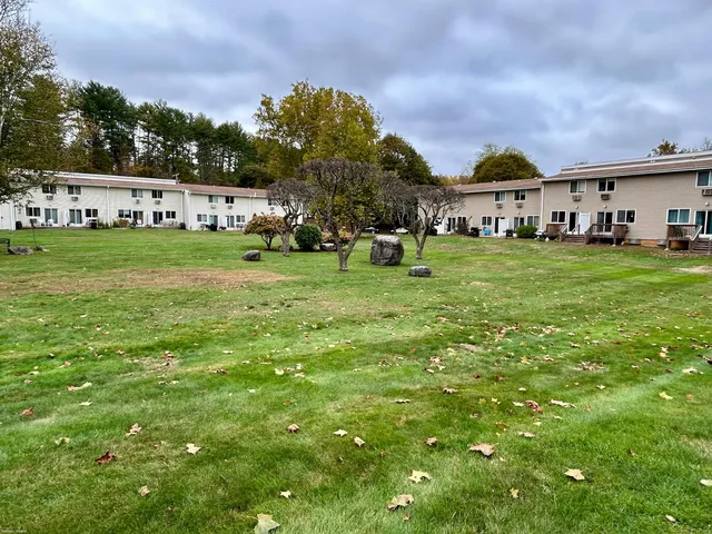 a view of a field of grass and trees