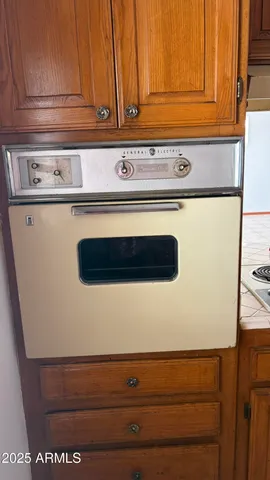 a view of a refrigerator in an empty room