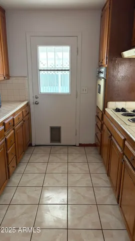 a kitchen with stainless steel appliances granite countertop a sink and a cabinets
