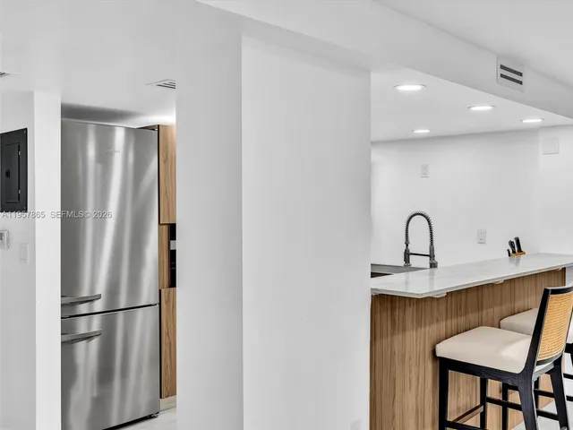 a kitchen with counter top space and living room