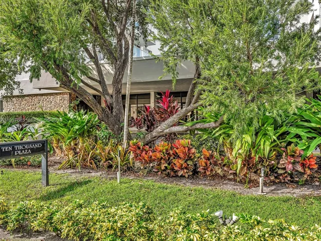 a living room with furniture and large windows