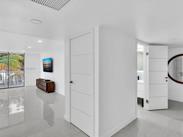 a kitchen with stainless steel appliances granite countertop a kitchen island a stove a sink and a refrigerator