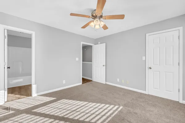 a view of a room with a ceiling fan