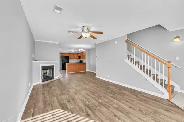 a view of a living room with furniture and a fireplace