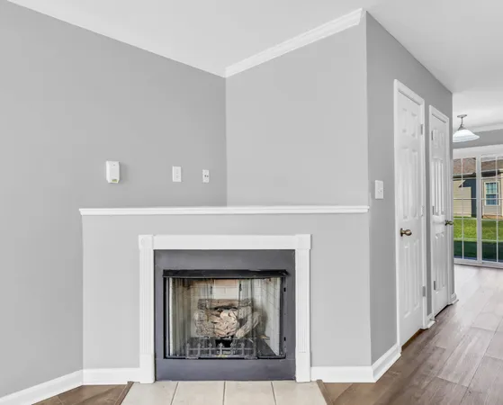 a living room with a fireplace and a painting on the wall
