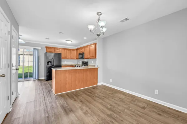 a view of a kitchen with wooden floor