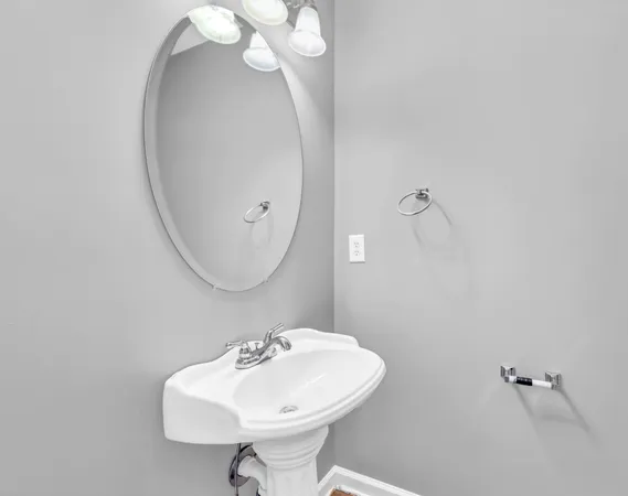 a bathroom with a sink a mirror and vanity