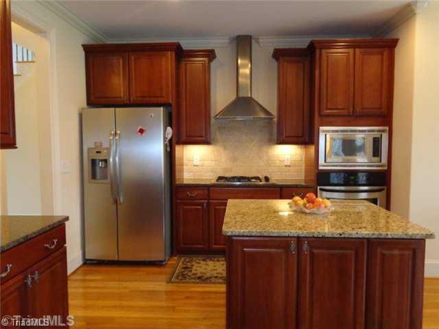 1702 Rita Court Oak Ridge, NC 27310 - Photo 5 of 16 Kitchen. Perfect cook s kitchen. An abundance of granite counter space.. Can lighting and loads of natural light. Features both breakfast area and breakfast bar
