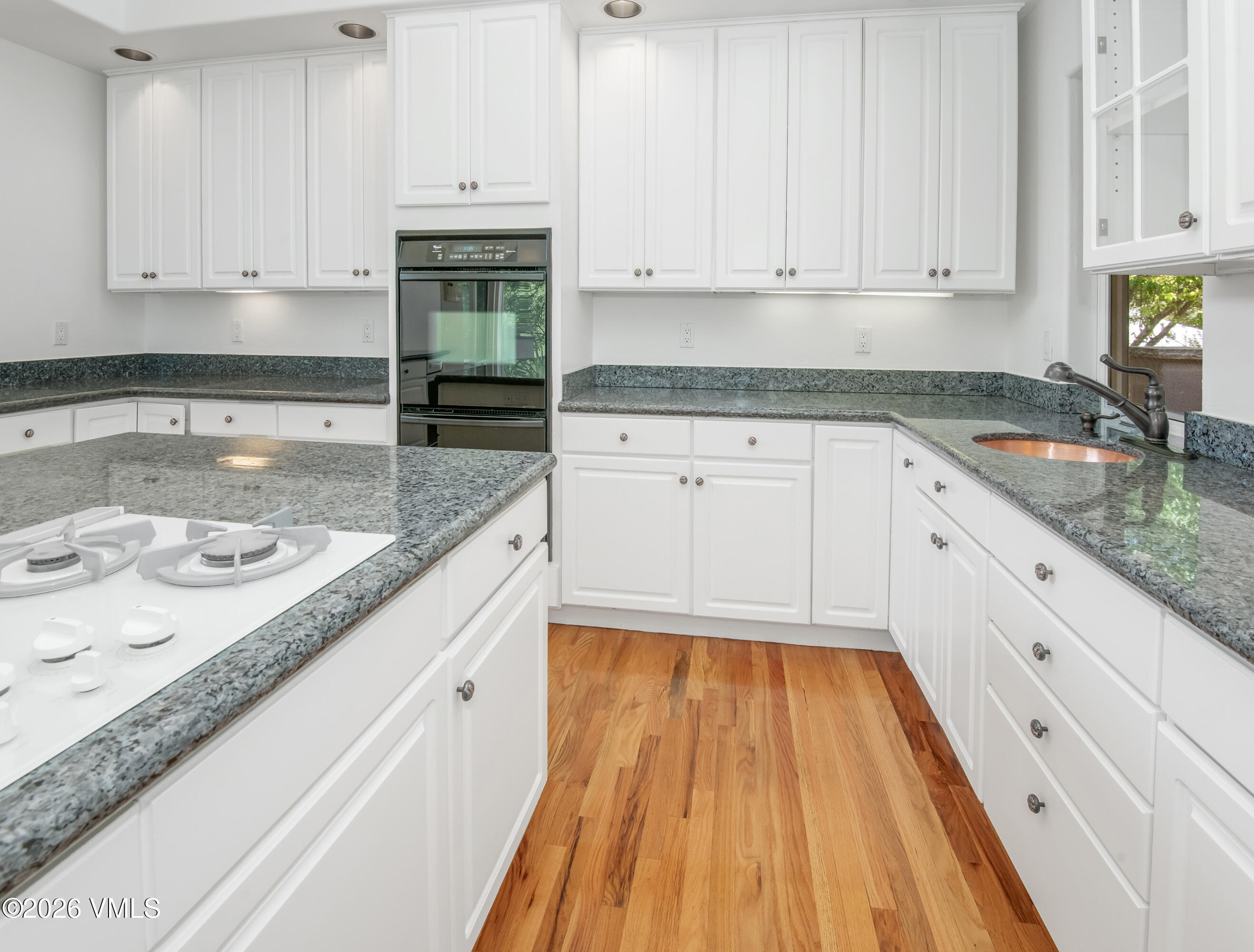 471 Rawhide Road Edwards, CO 81632 - Photo 14 of 51 a kitchen with granite countertop white cabinets and white appliances