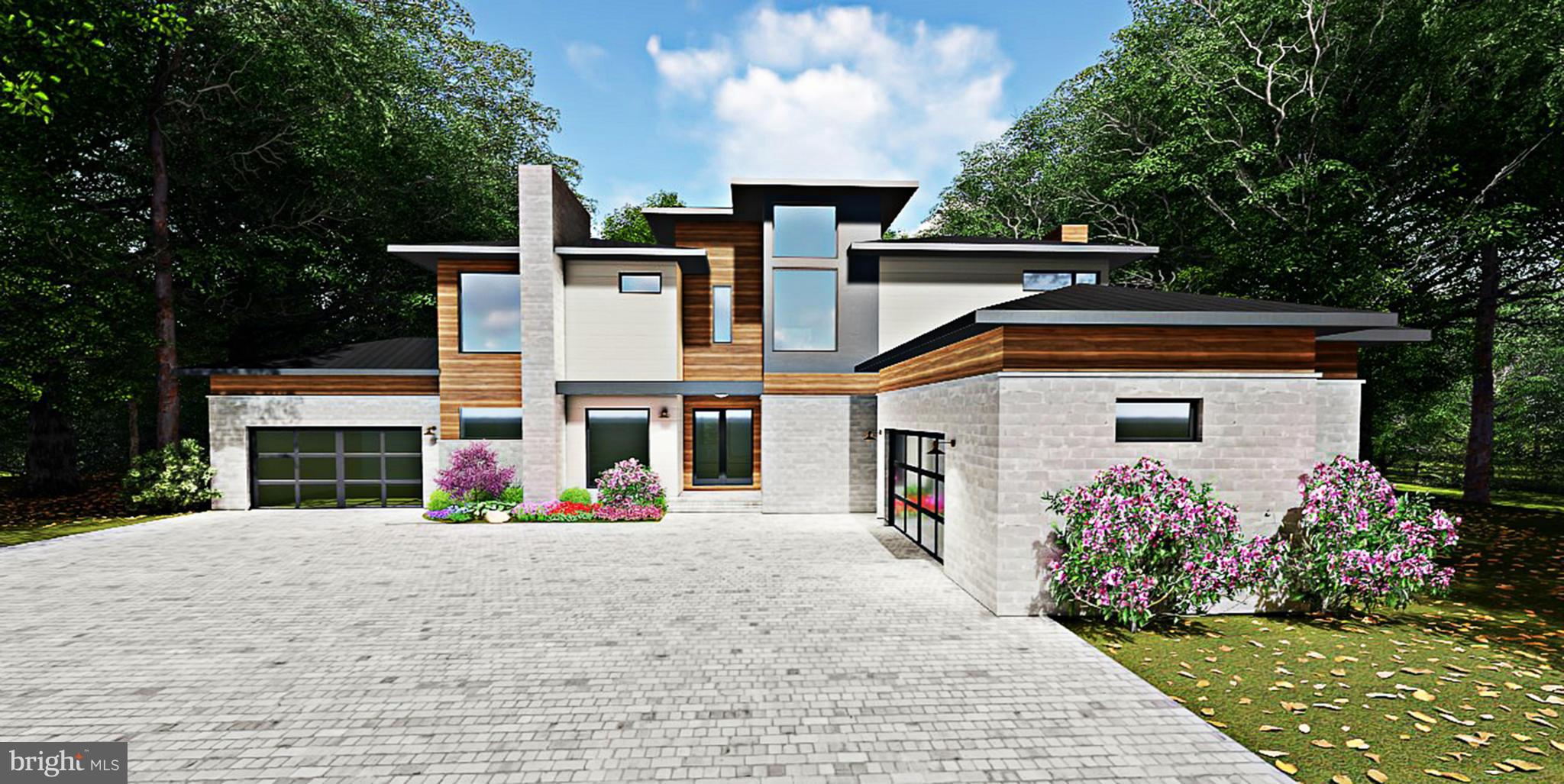 a view of a white house with a small yard plants and a large tree