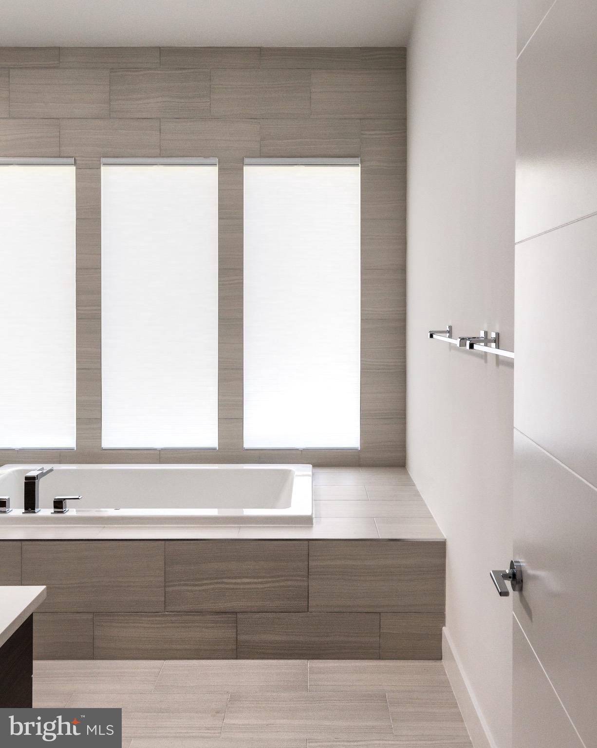 1217 Crest Lane McLean, VA 22101 - Photo 22 of 28 a bathroom with a bathtub and a window