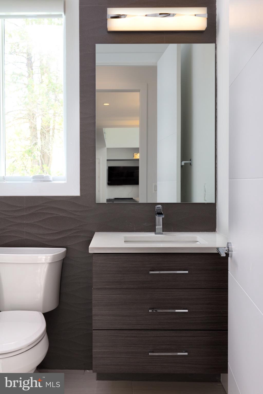 1217 Crest Lane McLean, VA 22101 - Photo 25 of 28 a bathroom with a toilet sink and mirror